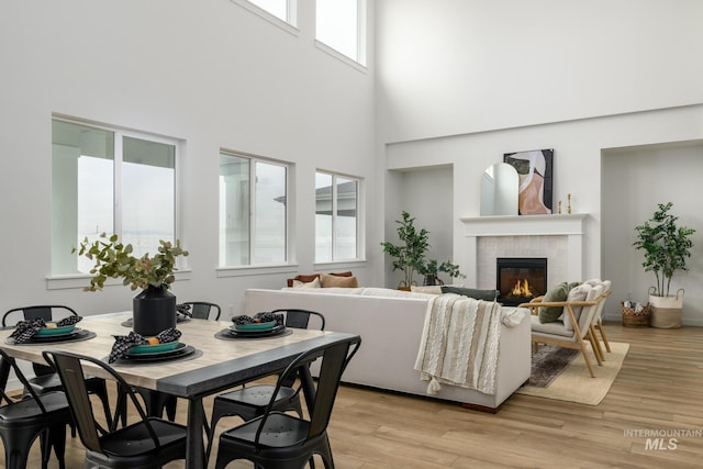 2005 N Spring Creek Ave, Middleton, ID 83644 - dining space featuring a tile fireplace, a high ceiling, and light wood-style flooring