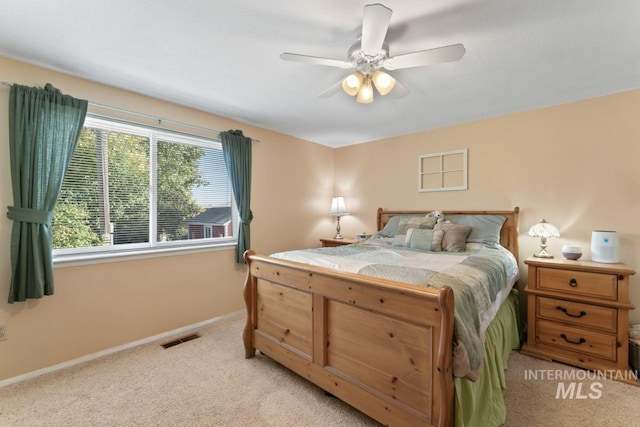 carpeted bedroom with ceiling fan