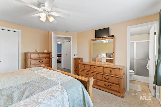 carpeted bedroom featuring ensuite bathroom and ceiling fan