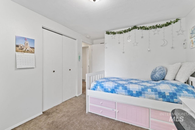 carpeted bedroom with a closet