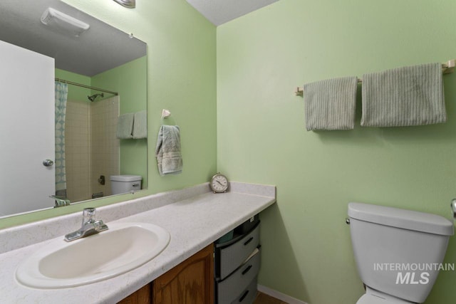 bathroom featuring toilet, a shower with curtain, and vanity