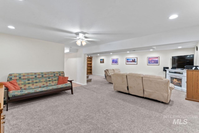 carpeted living room with ceiling fan