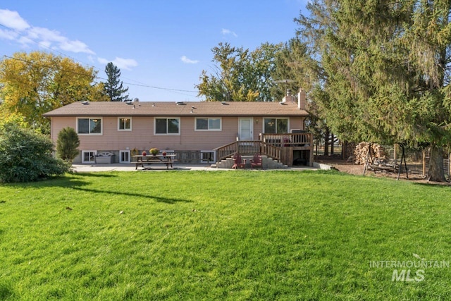 back of house featuring a patio, a deck, and a lawn