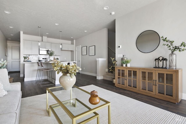 1694 N Solterra Ln, Meridian, ID 83646 - living area with a textured ceiling, baseboards, recessed lighting, and dark wood-style floors