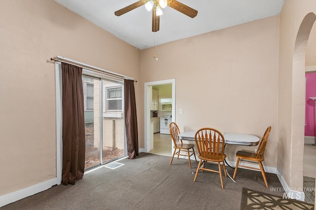 408 6th Ave, Lewiston, ID 83501 - dining room with arched walkways, a ceiling fan, and carpet