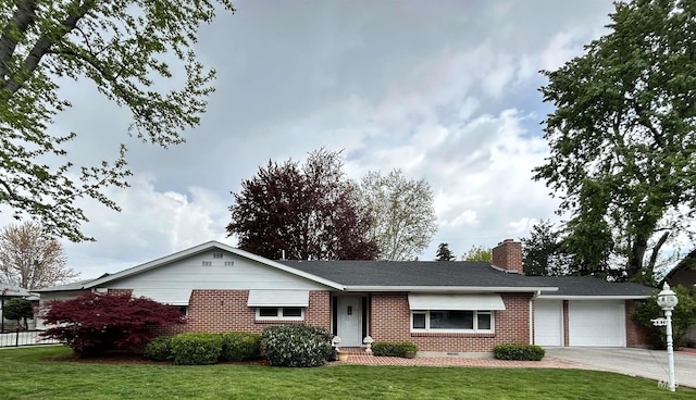 ranch-style home with brick siding, an attached garage, a front yard, and concrete driveway