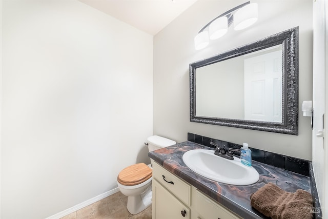 bathroom featuring tile flooring, toilet, and large vanity