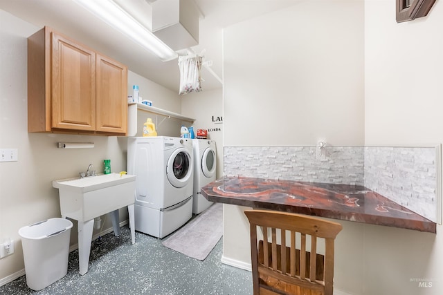 laundry area with cabinets and washer and clothes dryer