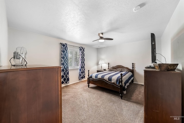 bedroom with ceiling fan, carpet, and a textured ceiling