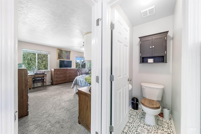 bathroom featuring ceiling fan and toilet