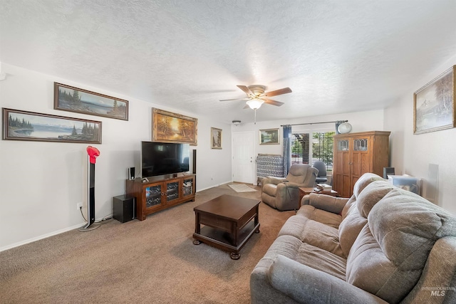 carpeted living room with ceiling fan and a textured ceiling