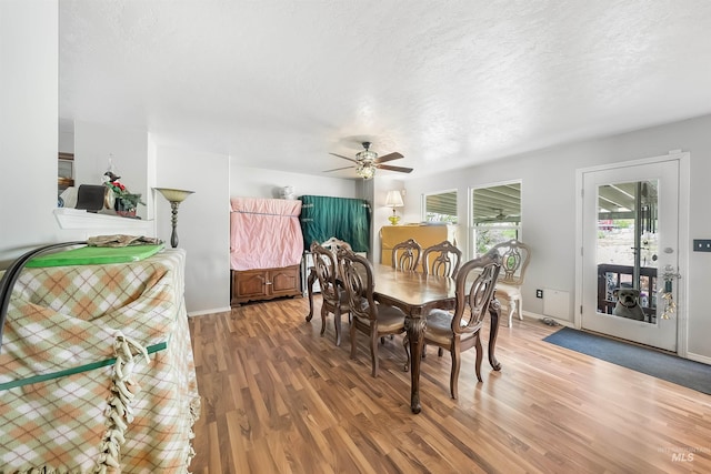 dining area featuring hardwood / wood-style flooring and ceiling fan