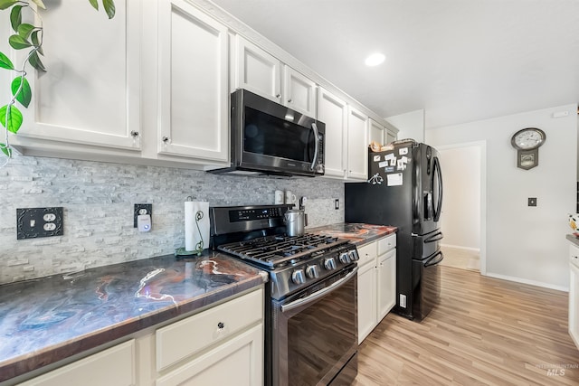 kitchen with white cabinetry, tasteful backsplash, light hardwood / wood-style floors, and gas range oven