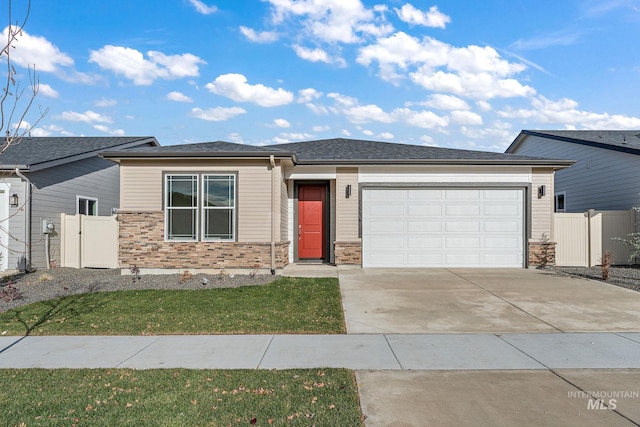 view of front of property with a gate, an attached garage, concrete driveway, and fence