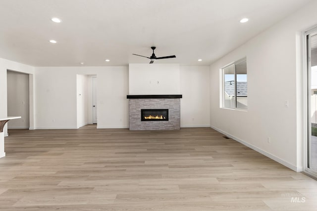 unfurnished living room with recessed lighting, light wood-type flooring, a ceiling fan, and a fireplace