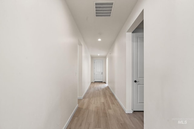 corridor with recessed lighting, visible vents, baseboards, and light wood-style flooring