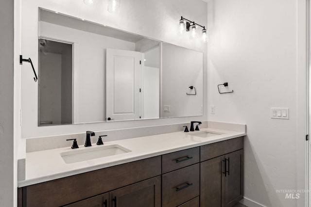 full bathroom featuring double vanity and a sink