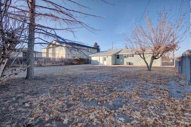 rear view of property with a fenced backyard