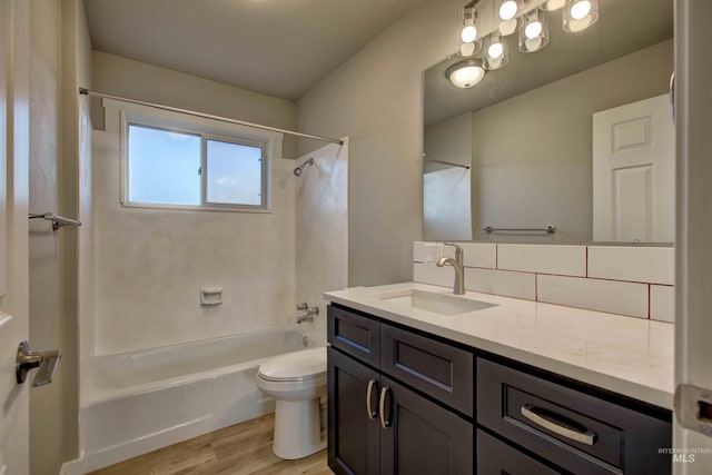 full bathroom featuring shower / bathing tub combination, wood-type flooring, backsplash, vanity, and toilet