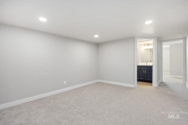 finished basement with light carpet, baseboards, and recessed lighting