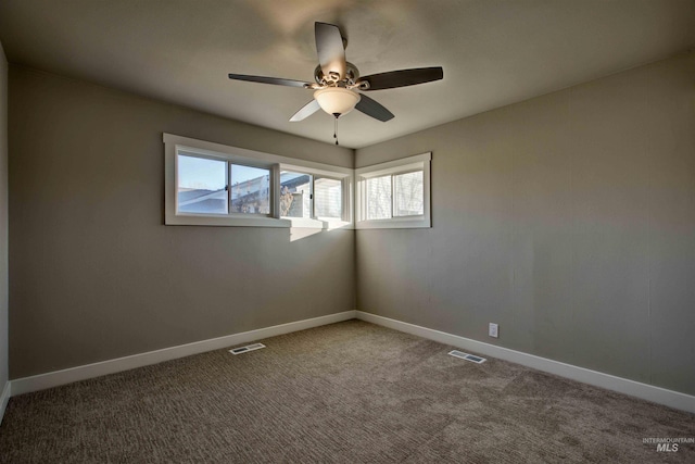 empty room with ceiling fan and carpet