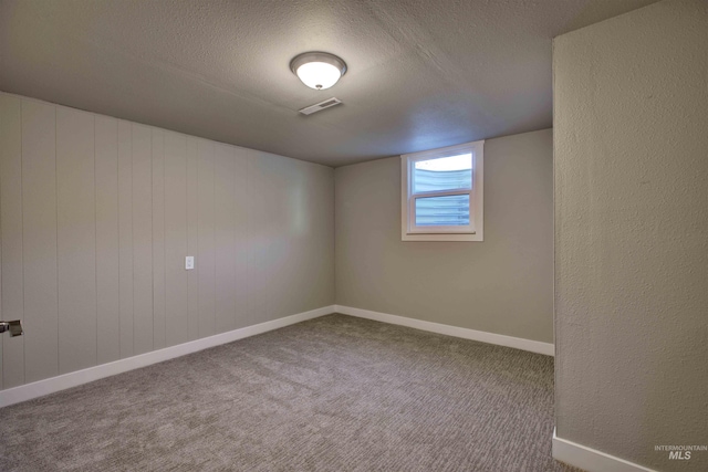 empty room featuring carpet floors and a textured ceiling