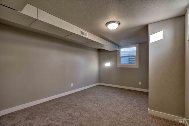 interior space featuring a textured ceiling and carpet flooring