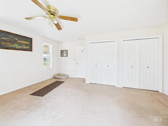 1334 Morehouse Rd, Emmett, ID 83617 - unfurnished bedroom with carpet flooring, two closets, a ceiling fan, and baseboards