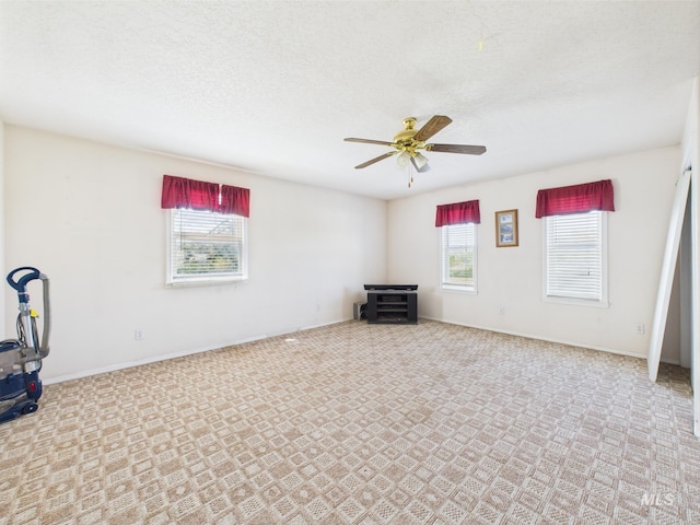 1334 Morehouse Rd, Emmett, ID 83617 - carpeted empty room with a ceiling fan, baseboards, and a textured ceiling