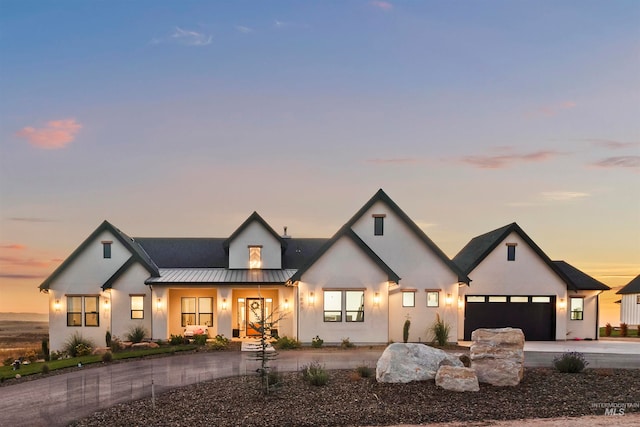 modern inspired farmhouse with covered porch and a garage