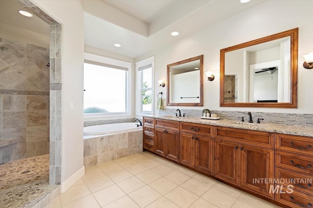 bathroom with a walk in shower, tile patterned flooring, recessed lighting, double vanity, and a garden tub