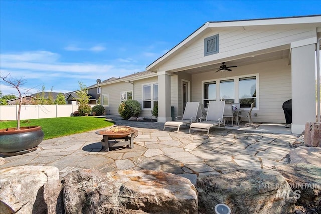 back of house with a fire pit, ceiling fan, and a patio area