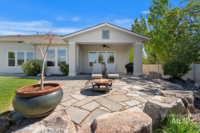back of property featuring a fire pit, ceiling fan, a patio area, and fence