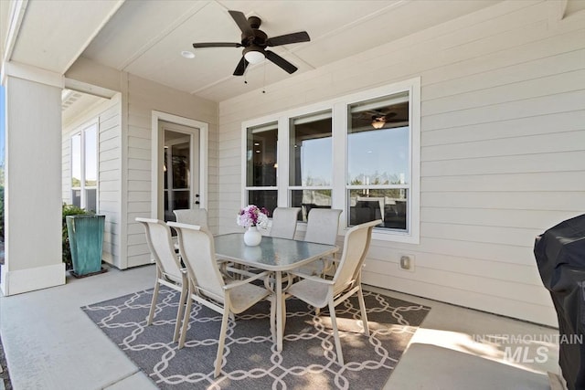 view of patio with a ceiling fan and outdoor dining area