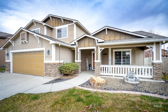 craftsman-style house with covered porch and a garage