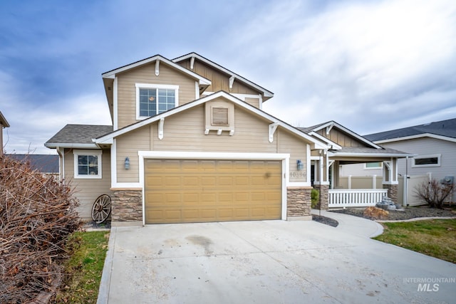 craftsman-style home with a porch and a garage