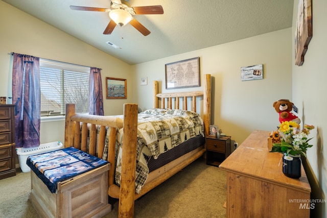 bedroom featuring a textured ceiling, ceiling fan, light carpet, and vaulted ceiling