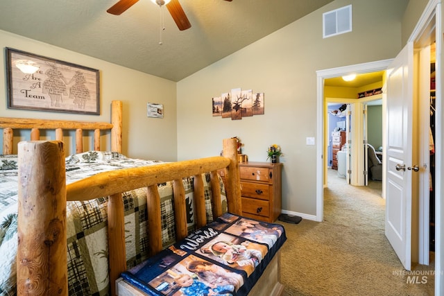 bedroom with ceiling fan, light colored carpet, lofted ceiling, and a textured ceiling