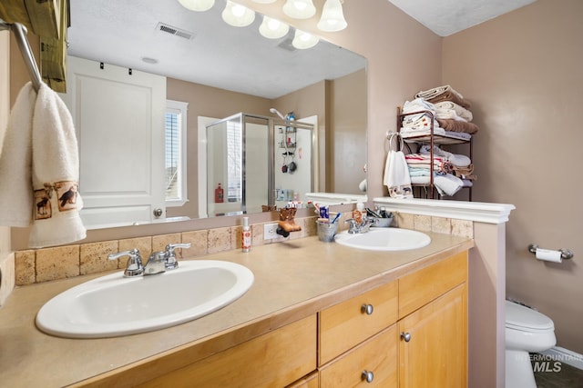 bathroom with vanity, toilet, and walk in shower