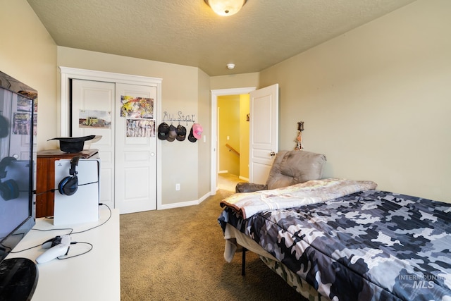 carpeted bedroom with a textured ceiling and a closet