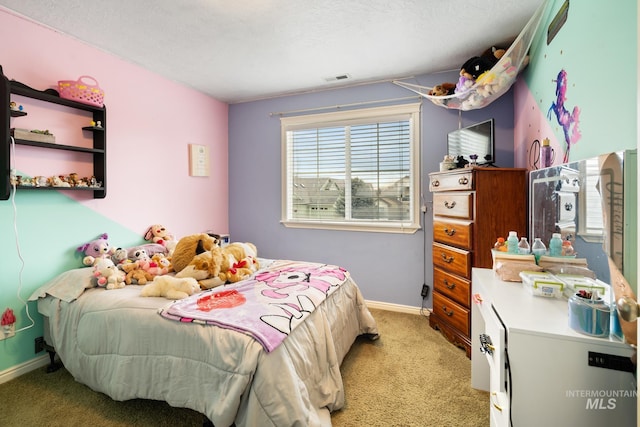 carpeted bedroom featuring a textured ceiling