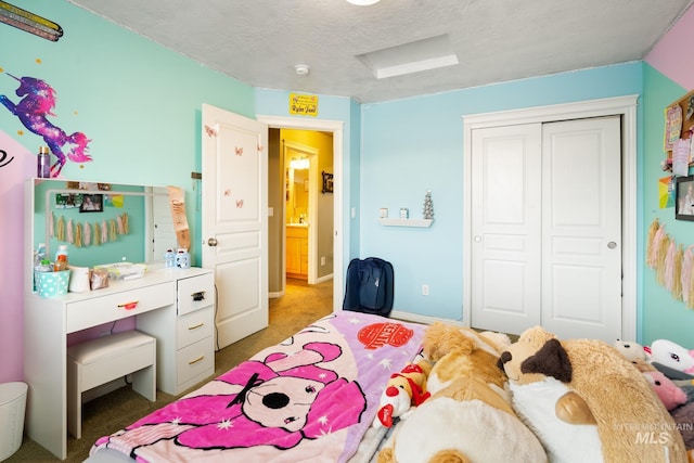 carpeted bedroom with a textured ceiling and a closet