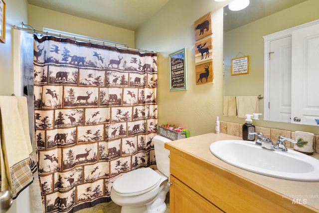 bathroom with a shower with curtain, vanity, and toilet