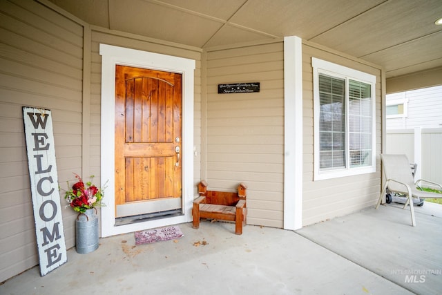 view of exterior entry with a porch