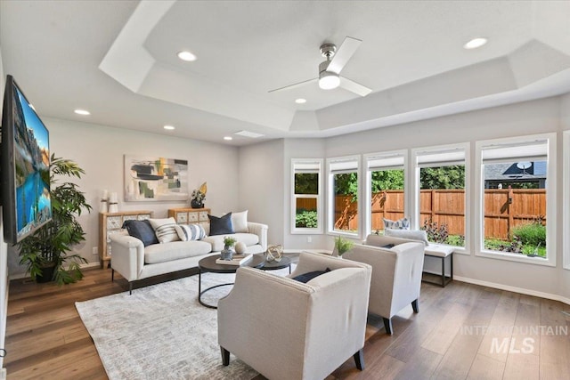 11298 W Charitan St, Boise, ID 83713 - living room featuring a raised ceiling, wood finished floors, ceiling fan, baseboards, and recessed lighting