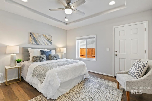 11298 W Charitan St, Boise, ID 83713 - bedroom with baseboards, wood finished floors, a tray ceiling, recessed lighting, and a ceiling fan