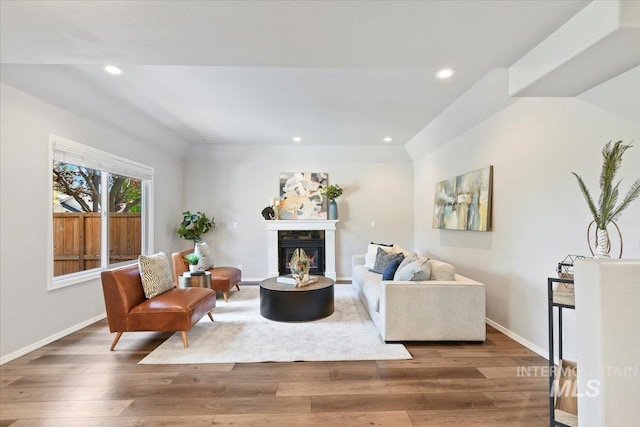 11298 W Charitan St, Boise, ID 83713 - living room with wood finished floors, recessed lighting, a glass covered fireplace, and baseboards