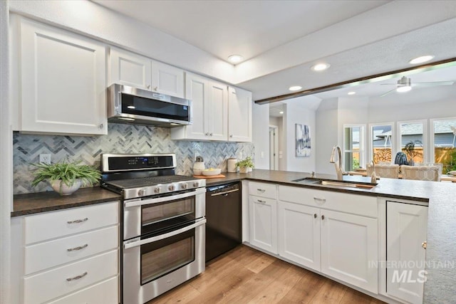 11298 W Charitan St, Boise, ID 83713 - kitchen with appliances with stainless steel finishes, a sink, white cabinetry, tasteful backsplash, and recessed lighting