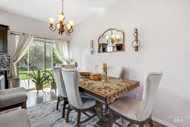 dining area featuring a notable chandelier and wood-type flooring