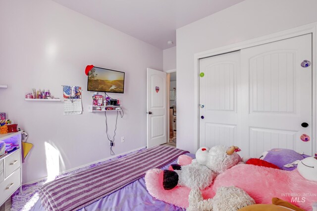 carpeted bedroom with a closet